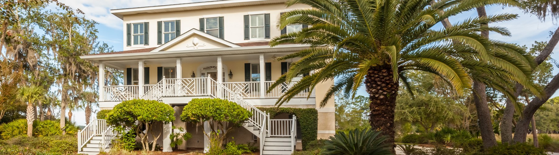 two story home with palm trees